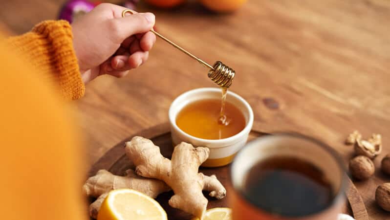 Honey, Ginger, Sliced Lemon and Tea In a Wooden Tray