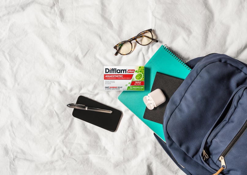 Difflam Plus Anaesthetic Sore Throat Lozenges Pineapple & Lime Flavour - Lifestyle Image Out Of Backpack